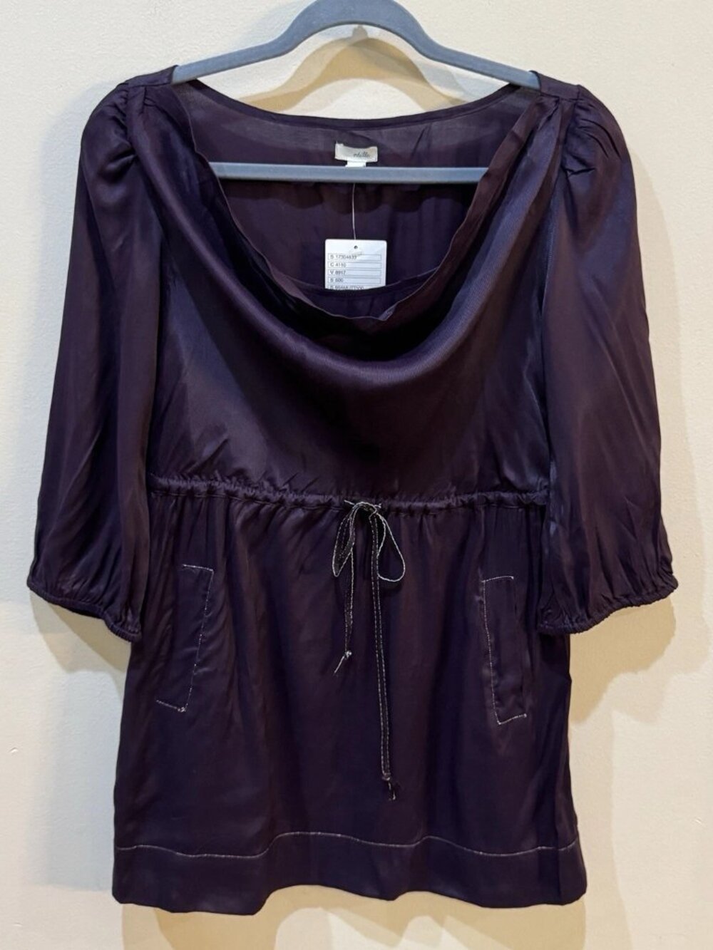 The long coat in the wine red color of the Anthropologie brand